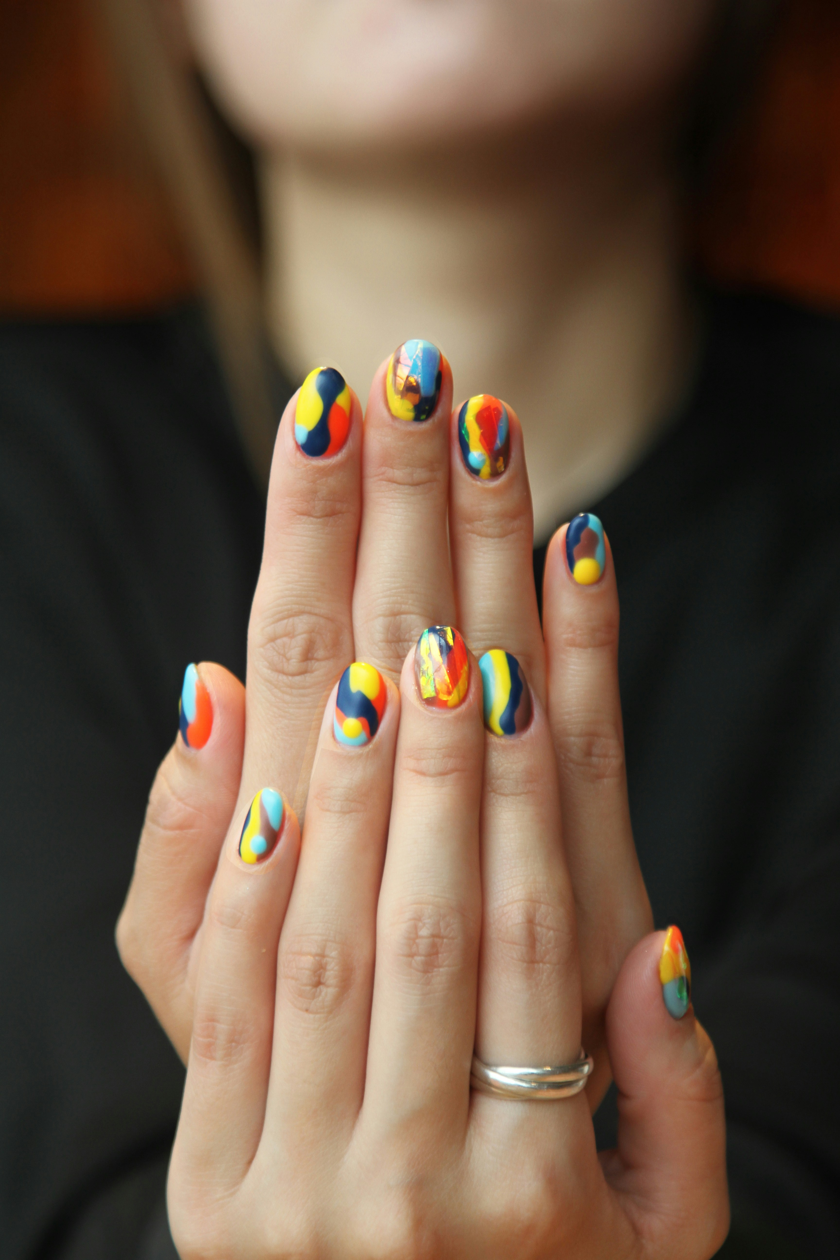 Minimal line-art nail design holding a cosmetic pen