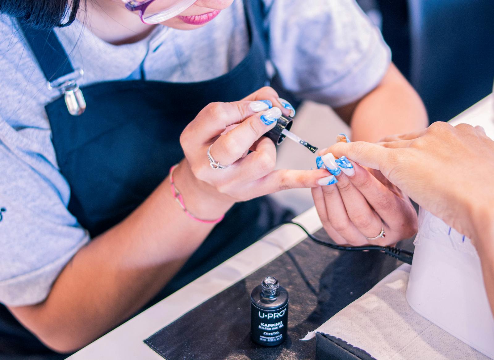 Nail technician providing a professional manicure service